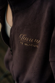 Brown garment with gold embroidery on a blurred background