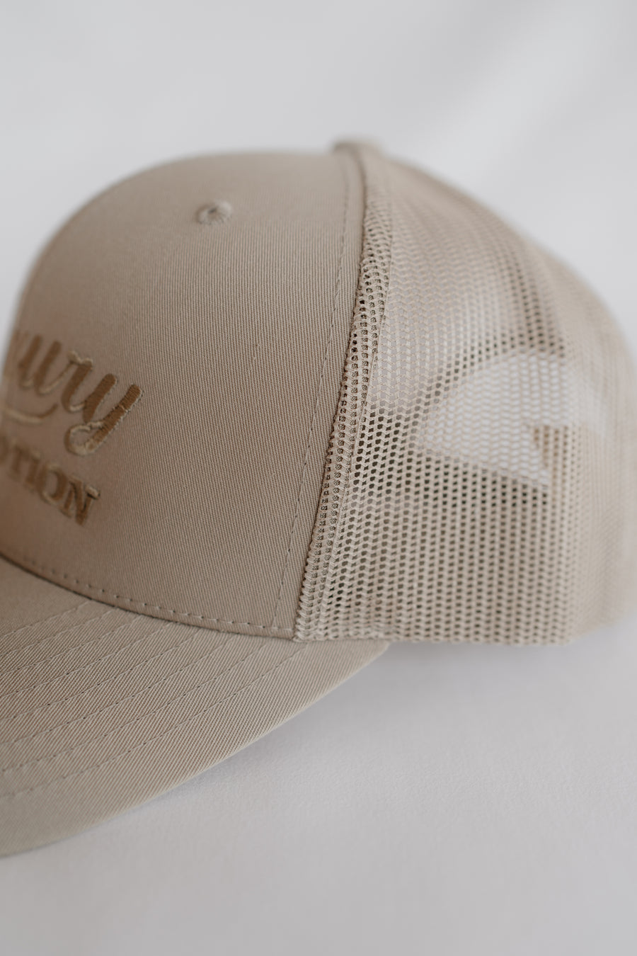 Beige cap with mesh back on a white background
