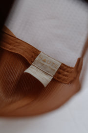 Brown fabric with a 'HAUTE' label on a white background