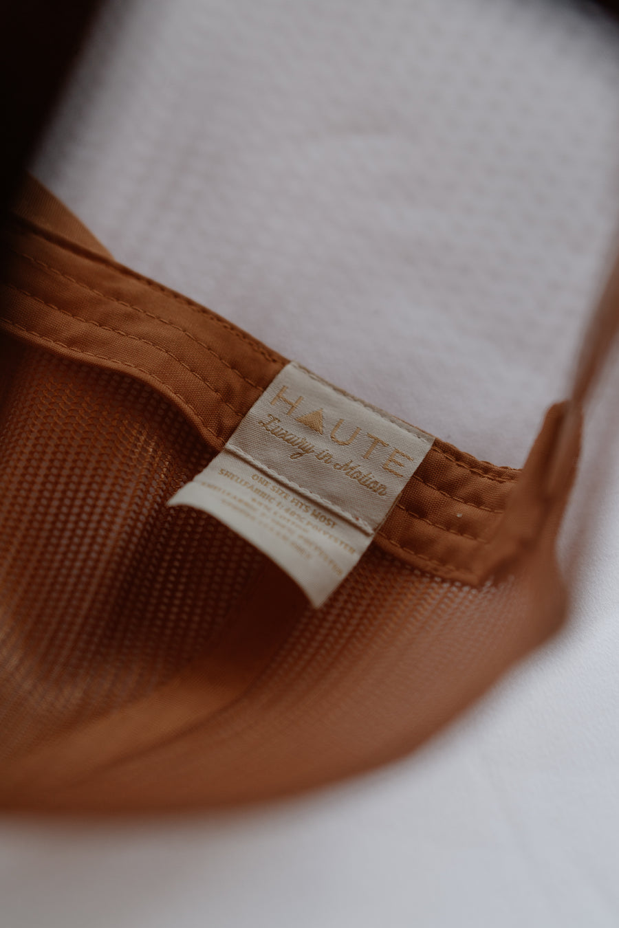 Brown fabric with a 'HAUTE' label on a white background