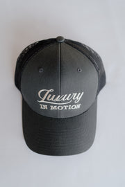 Grey cap with 'Luxury in Motion' text on a white background