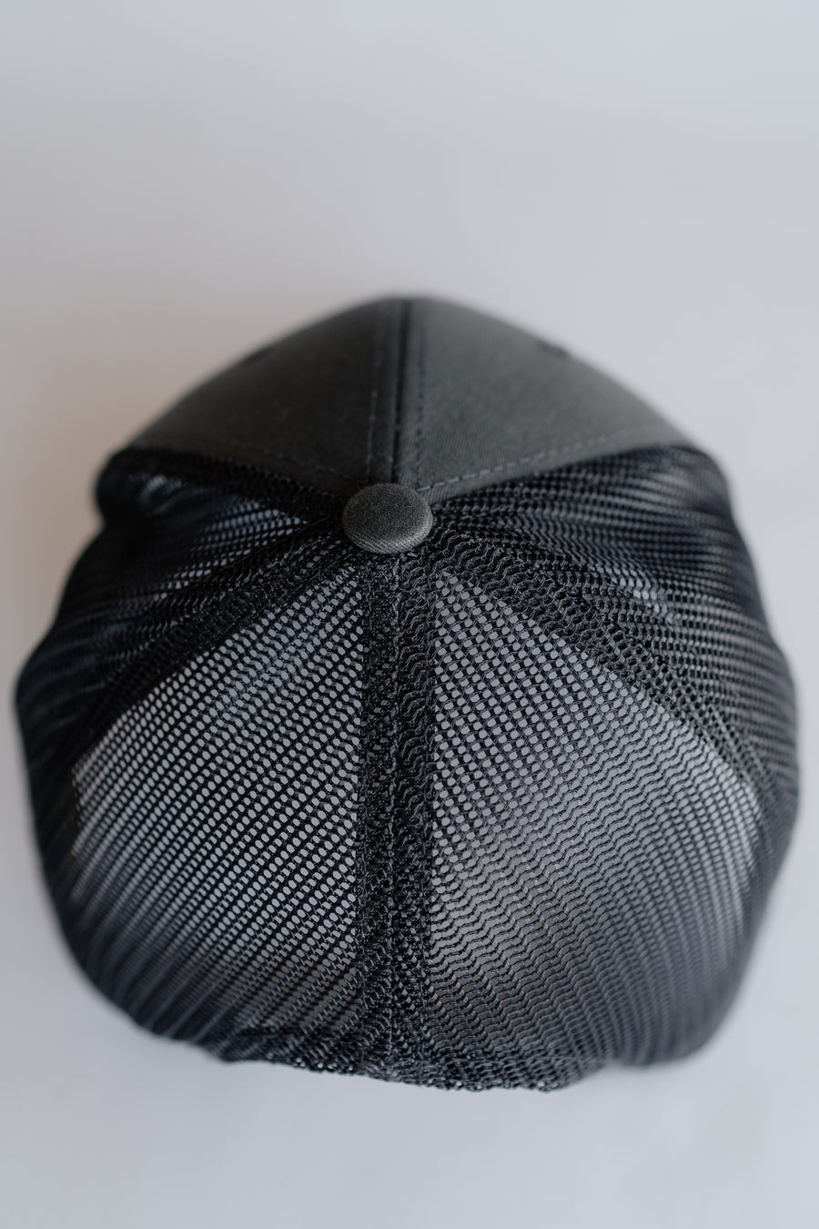 Grey mesh cap on a light gray background