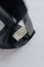 Grey cap with a visible brand tag on a light  background