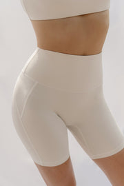 Beige shapewear shorts worn by a person on a plain background