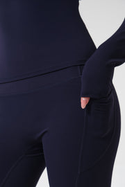 Navy blue athletic outfit with a focus on the pants on a white background