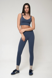 Woman wearing a blue athletic outfit on a white background