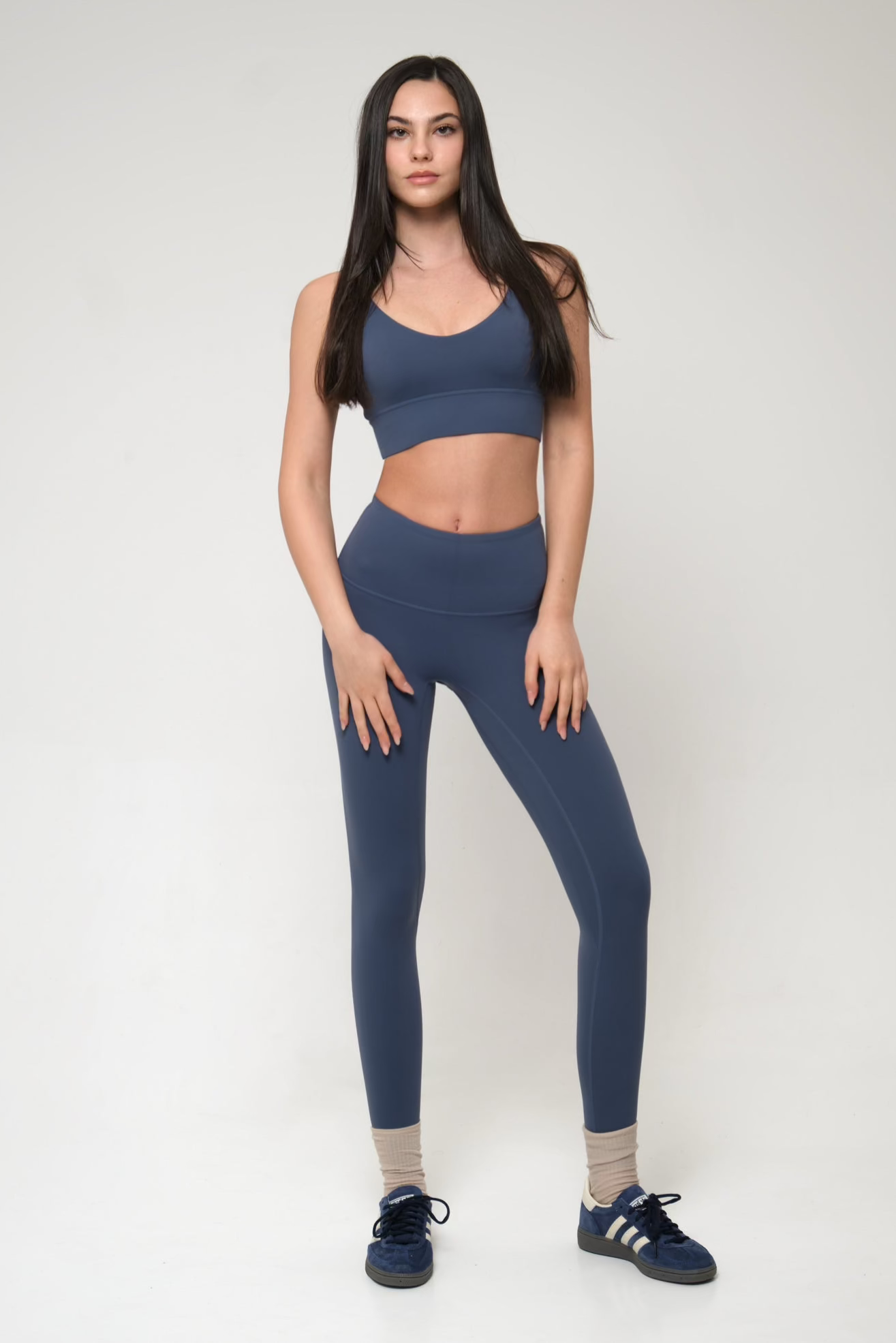 Woman wearing a blue athletic outfit on a white background