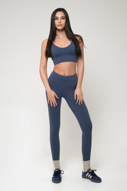Woman wearing a blue athletic outfit on a white background